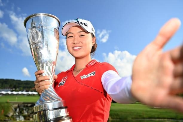 Tournament winner Minjee Lee of Australia imitates a selfie as she poses for a photo with her trophy during day four of the The Amundi Evian...