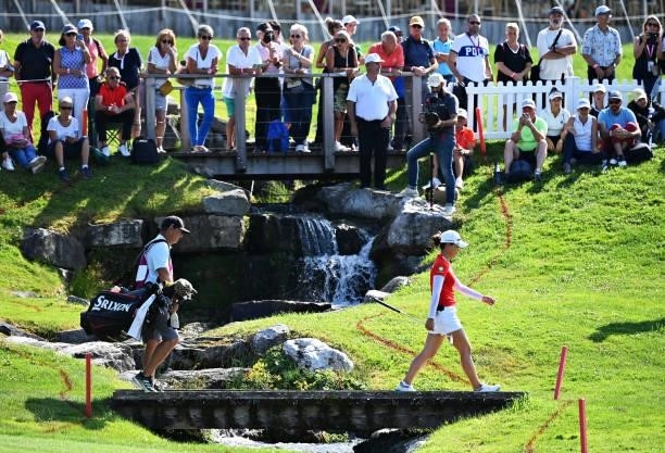 Minjee Lee of Australia walks over a bridge on the eighteenth hole during day four of the The Amundi Evian Championship at Evian Resort Golf Club on...