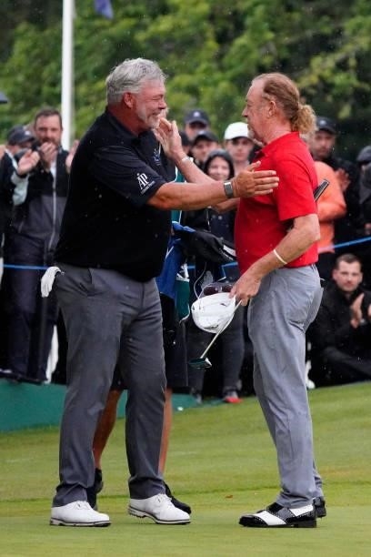 Darren Clarke of Northern Ireland shakes hands with Miguel Angel Jimenez of Spain during the final round of the Senior Open presented by Rolex at...