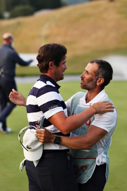 Tournament winner Nacho Elvira of Spain hugs his caddy after winning the playoff hole on the eighteenth green during Day Four of the Cazoo Open...