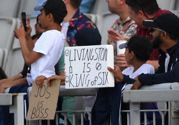 Cricket fan holds up a sign saying that " Livingstone is the king of six