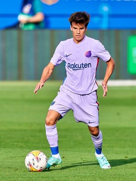 Riqui Puig of FC Barcelona with the ball during a friendly match between FC Barcelona and Girona FC at Estadi Johan Cruyff on July 24, 2021 in...