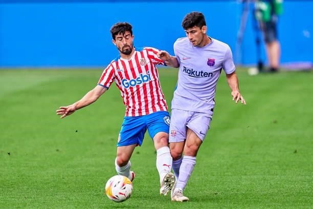 Yusuf Demir of FC Barcelona competes for the ball with Jairo Morillas of Girona FC during a friendly match between FC Barcelona and Girona FC at...
