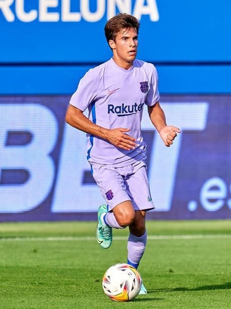 Riqui Puig of FC Barcelona with the ball during a friendly match between FC Barcelona and Girona FC at Estadi Johan Cruyff on July 24, 2021 in...
