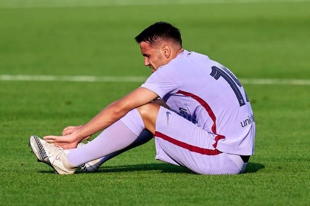 Rey Manaj of FC Barcelona lies injured during a friendly match between FC Barcelona and Girona FC at Estadi Johan Cruyff on July 24, 2021 in...
