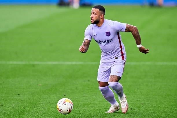 Memphis Depay of FC Barcelona with the ball during a friendly match between FC Barcelona and Girona FC at Estadi Johan Cruyff on July 24, 2021 in...