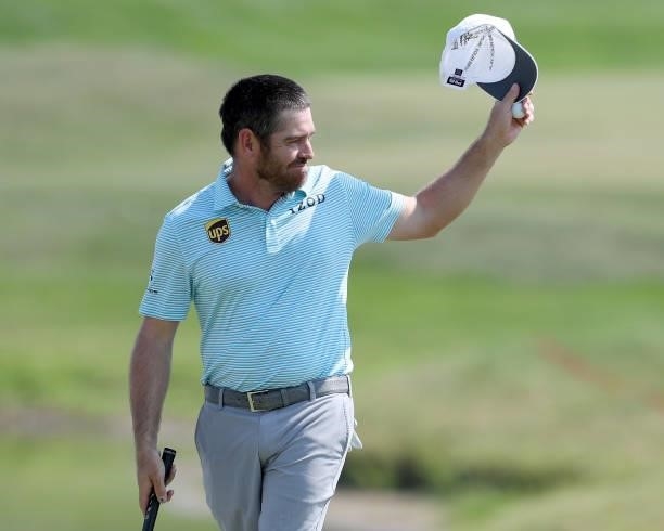 Louis Oosthuizen of South Africa waves to the crowd on the 18th green after his round during the final round of the 3M Open at TPC Twin Cities on...