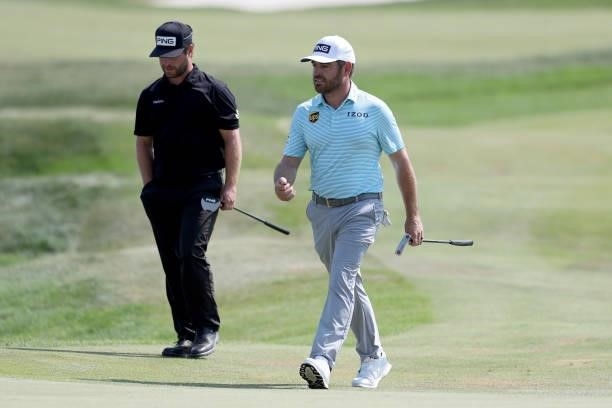 David Lingmerth of Sweden and Louis Oosthuizen of South Africa walk to the 18th green during the final round of the 3M Open at TPC Twin Cities on...