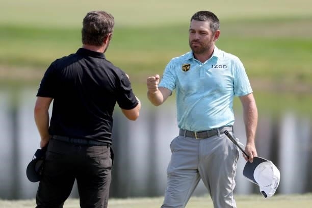David Lingmerth of Sweden and Louis Oosthuizen of South Africa first bump on the 18th green after their rounds during the final round of the 3M Open...