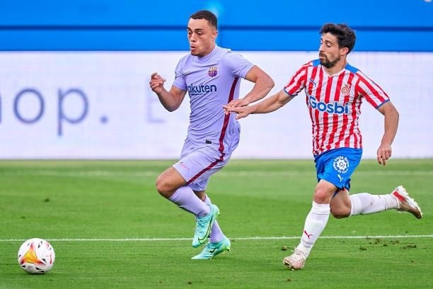 Sergino Dest of FC Barcelona competes for the ball with Jairo Morillas of Girona FC during a friendly match between FC Barcelona and Girona FC at...