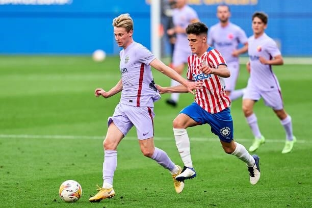 Frenkie De Jong of FC Barcelona competes for the ball during a friendly match between FC Barcelona and Girona FC at Estadi Johan Cruyff on July 24,...