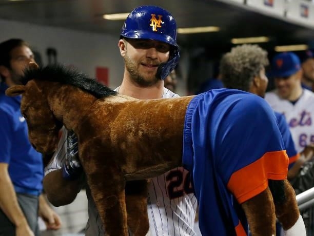 Pete Alonso of the New York Mets celebrates his eighth inning home run against the Toronto Blue Jays with the 'Home Run Horse' in the dugout at Citi...
