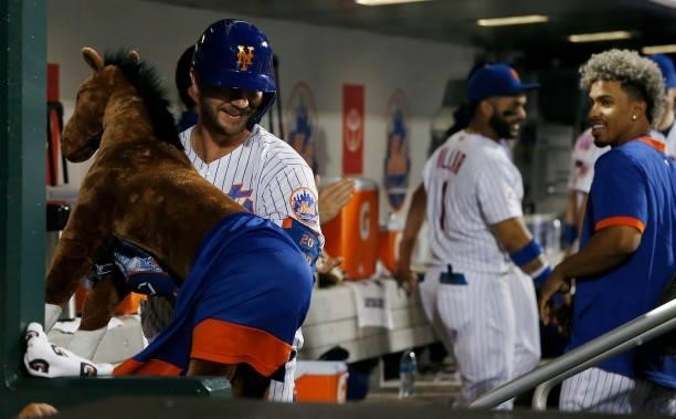 Pete Alonso of the New York Mets celebrates his eighth inning home run against the Toronto Blue Jays with the 'Home Run Horse' in the dugout at Citi...