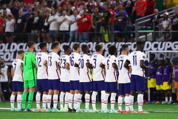 United States players stand for their national anthem before the quarterfinal match between United States and Jamaica as part of 2021 CONCACAF Gold...