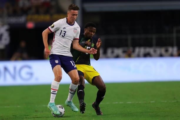 Matthew Hoppe of United States and Alvas Powell of Jamaica fight for the ball during the quarterfinal match between United States and Jamaica as part...