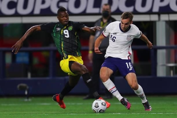 Matthew Hoppe of United States and Alvas Powell of Jamaica fight for the ball during to the a quarterfinal match between United States and Jamaica as...