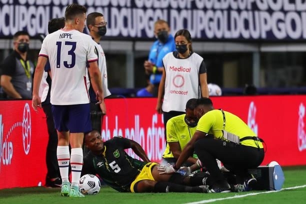 Alvas Powell of Jamaica complains of an injury during to the a quarterfinal match between United States and Jamaica as part of 2021 CONCACAF Gold Cup...