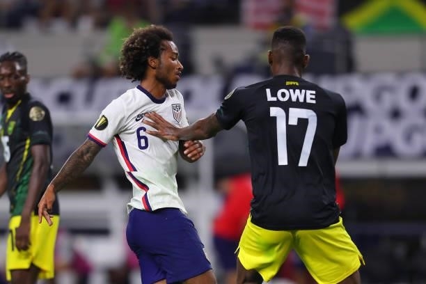 Damion Lowe of Jamaica pushes Gianluca Busio of United States during the quarterfinal match between United States and Jamaica as part of 2021...