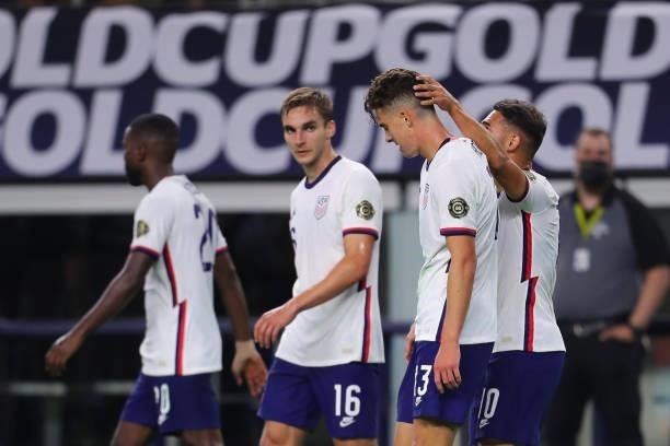 Matthew Hoppe of United States celebrates with his teammates after scoring his team's first goal during the quarterfinal match between United States...