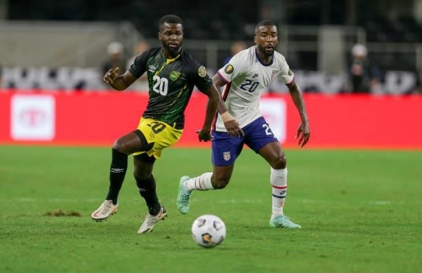 Shaq Moore of the United States and Kemar Lawrence of Jamaica battle for a ball during a game between Jamaica and USMNT at AT&T Stadium on July 25,...