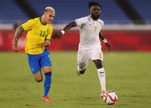 Antony of Team Brazil competes for the ball with Ismael Diallo of Team Ivory Coast during the Men's First Round Group D match on day two of the Tokyo...