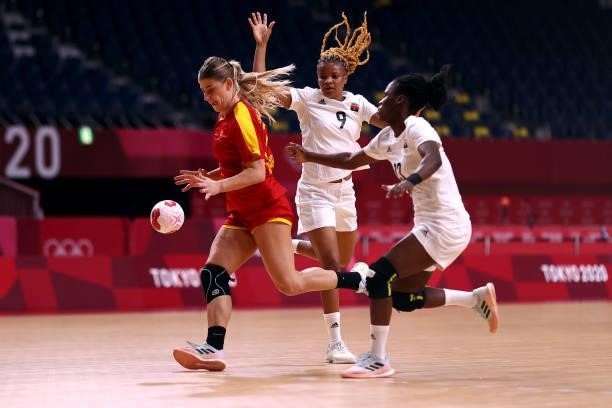Majda Mehmedovic of Team Montenegro gets past the tackle from Natalia Santos and Natalia Fonseca of Team Angola during the Women's Preliminary Round...