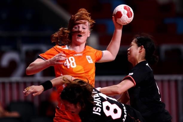 Dione Housheer of Team Netherlands passes the ball whilst under pressure from Mayuko Ishitate and Yuki Tanabe of Team Japan during the Women's...