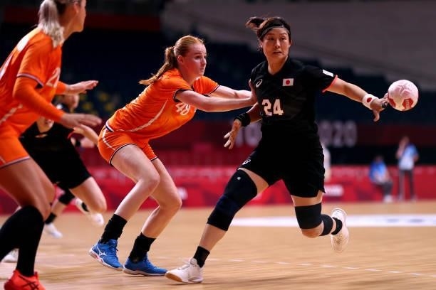 Nozomi Hara of Team Japan is challenged by Dione Housheer of Team Netherlands during the Women's Preliminary Round Group A match between Netherlands...