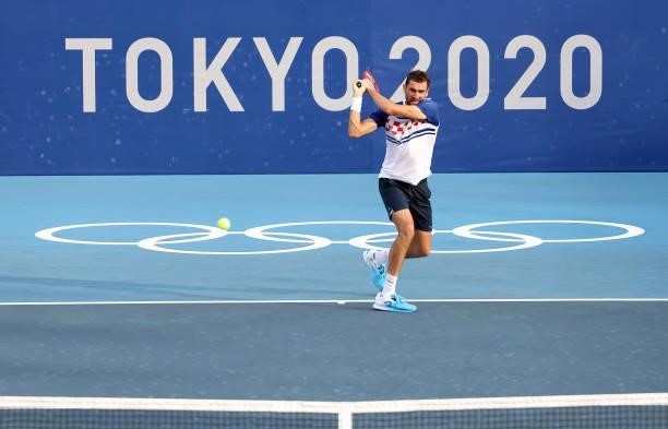 Marin Cilic of Team Croatia plays a backhand during his Men's Singles Second Round match against Pablo Carreno Busta of Team Spain on day three of...