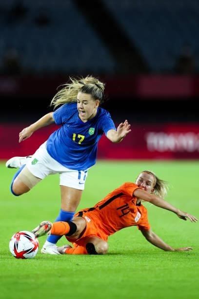 Andressinha of Brazil competes for the ball with Groenen Jackie of Netherland during the Women's First Round Group F match on day one of the Tokyo...