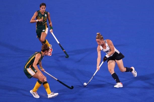 Susannah Townsend of Team Great Britain controls the ball whilst under pressure during the Women's Preliminary Pool A match between South Africa and...