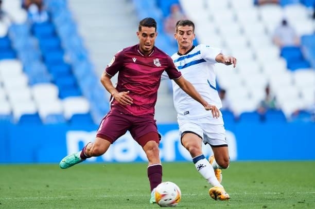 Roberto Lopez Alcaide of Real Sociedad duels for the ball with Pere Pons of Deportivo Alaves during the Friendly Match between Real Sociedad and...
