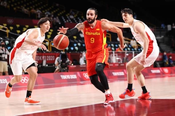 Ricky Rubio of Team Spain drives past Daiki Tanaka and Avi Koki Schafer of Team Japan during the second half of the Men's Preliminary Round Group C...