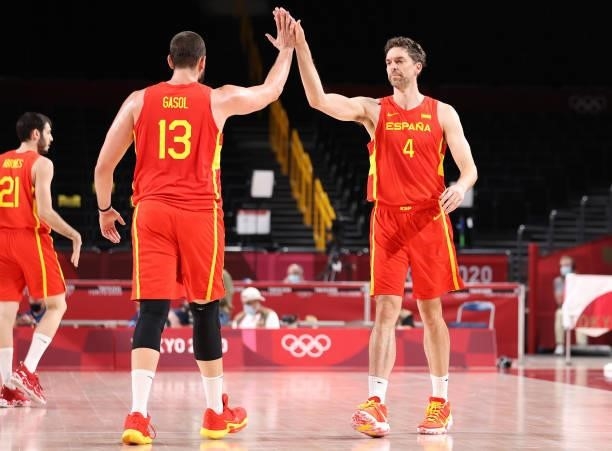 Pau Gasol of Team Spain high fives his brother Marc Gasol during the first half of the Men's Preliminary Round Group C game on day three of the Tokyo...