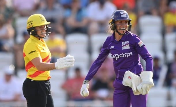 Superchargers wicketkeeper Lauren Winfield-Hill and Rockets batter Katherine Brunt share a joke after colliding during the Hundred match between...