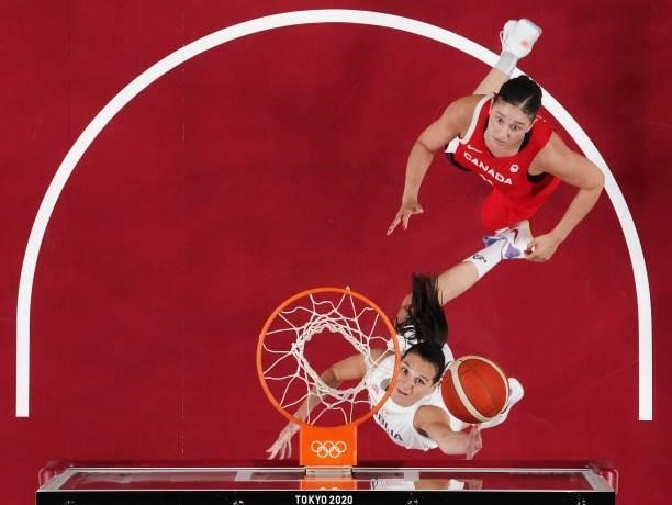 Sonja Vasic of Team Serbia drives past Natalie Achonwa of Team Canada for a layup during the first half of the Men's Preliminary Round Group C game...