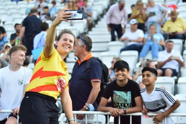 Kathryn Bryce of Trent Rockets takes a selfie with fans during The Hundred match between Trent Rockets and Northern Superchargers at Trent Bridge on...