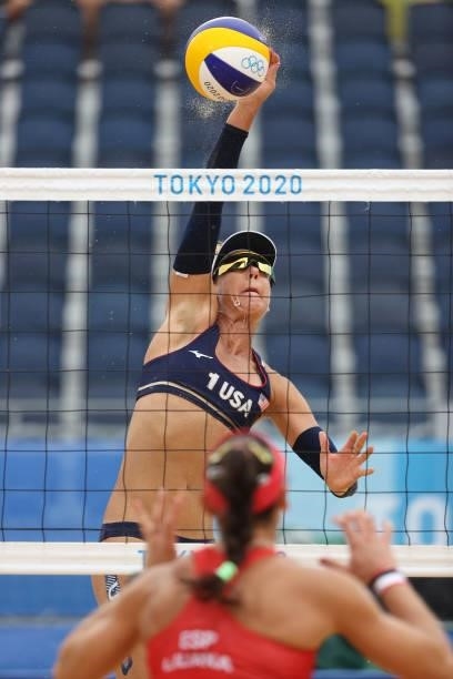 April Ross of Team United States hits against Team Spain during the Women's Preliminary - Pool B beach volleyball on day four of the Tokyo 2020...