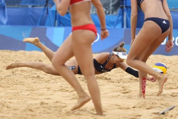 April Ross of Team United States dives in an attempted return against Team Spain during the Women's Preliminary - Pool B beach volleyball on day four...