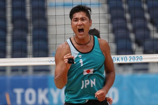 Yusuke Ishijima of Team Japan celebrates against Team Italy during the Men's Preliminary - Pool F beach volleyball on day four of the Tokyo 2020...