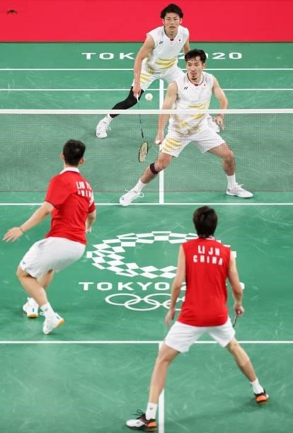 Takeshi Kamura and Keigo Sonoda of Team Japan compete against Li Jun Hui and Liu Yu Chen of Team China during a Men's Doubles Group C match on day...