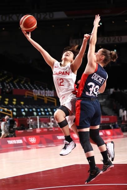 Naho Miyoshi of Team Japan goes up for a shot against Alix Duchet of Team France during the first half of a Women's Preliminary Round Group B game on...