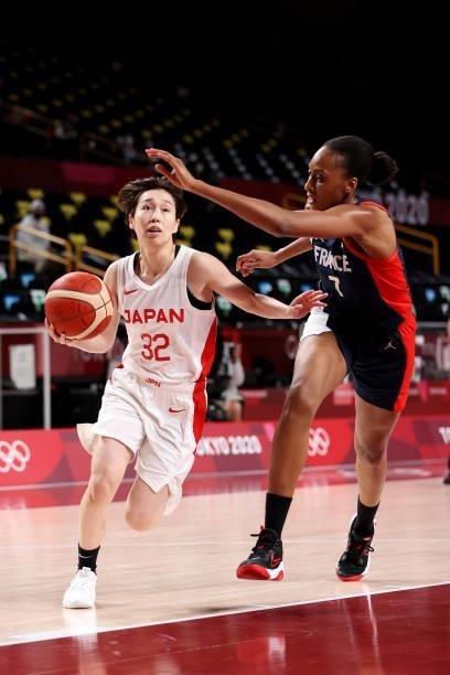 Saori Miyazaki of Team Japan drives to the basket against Sandrine Gruda of Team France during the first half of a Women's Preliminary Round Group B...