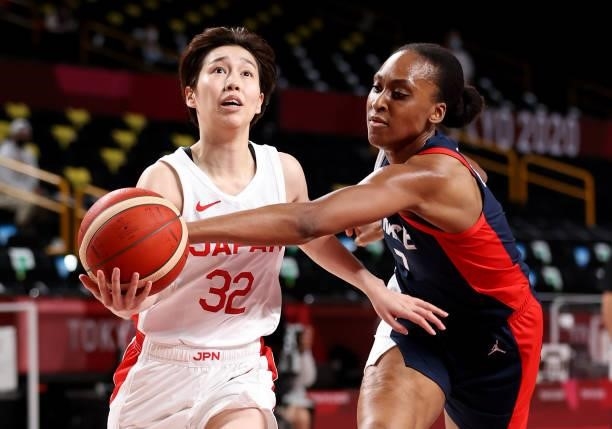 Sandrine Gruda of Team France gets a hold of the ball as Saori Miyazaki of Team Japan drives to the basket during the first half of a Women's...