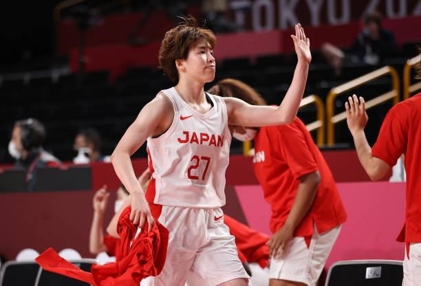 Saki Hayashi of Team Japan is congratulated by teammates as she comes to the bench against France during a Women's Preliminary Round Group B game on...