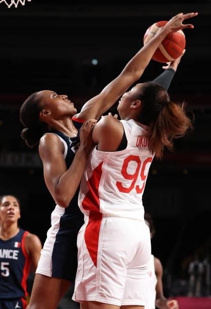 Monica Okoye of Team Japan is defended by Sandrine Gruda of Team France during the first half of a Women's Preliminary Round Group B game on day four...
