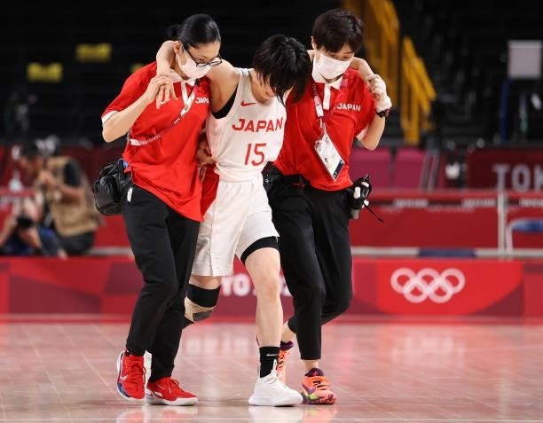 Nako Motohashi of Team Japan is helped off the court after an injury against France during a Women's Preliminary Round Group B game on day four of...