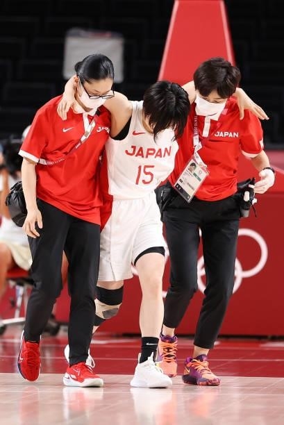 Nako Motohashi of Team Japan is helped off the court after an injury against France during a Women's Preliminary Round Group B game on day four of...