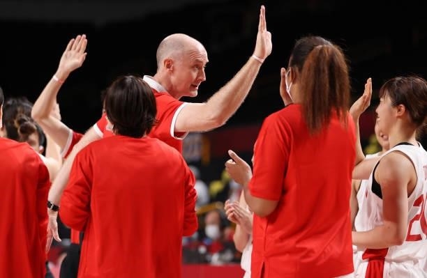 Head coach Tom Hovasse of Team Japan celebrates a win against France with his team during a Women's Preliminary Round Group B game on day four of the...