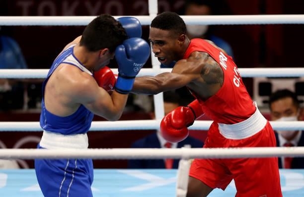 Merven Clair of Mauritius exchanges punches with Zeyad Eishaih Hussein of Jordan during the Men's Welter on day four of the Tokyo 2020 Olympic Games...